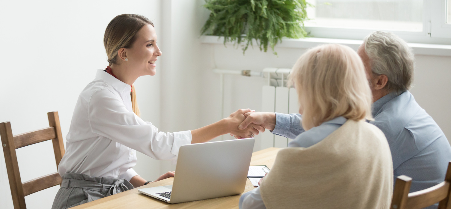 Mægler og par giver håndtryk